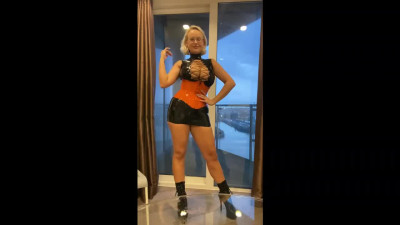 Hot chick with huge silicone tits poses in front of the camera