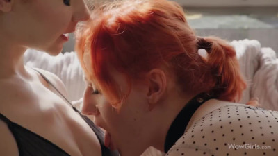 Red-haired lesbians sensually exchange oral sex in an erotic scene.