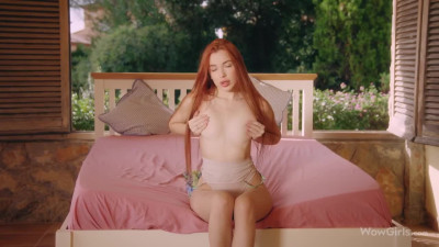 Ginger teen Megan gently touches herself on the bed