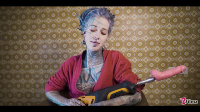Peculiar chick with a tattooed body masturbates her holes with toys with passion
