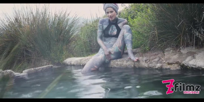 Extravagant chick squirts brightly from a tattooed penis and anal sex at hot springs