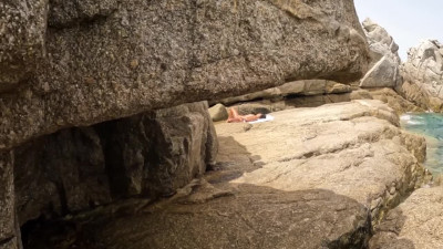 Slutty Ebony gives head right on a beach for a white stranger