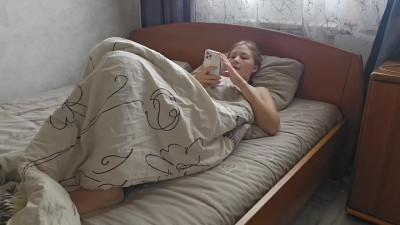 Hot girl watches porn on her smartphone and fingers her pussy moaning in pleasure